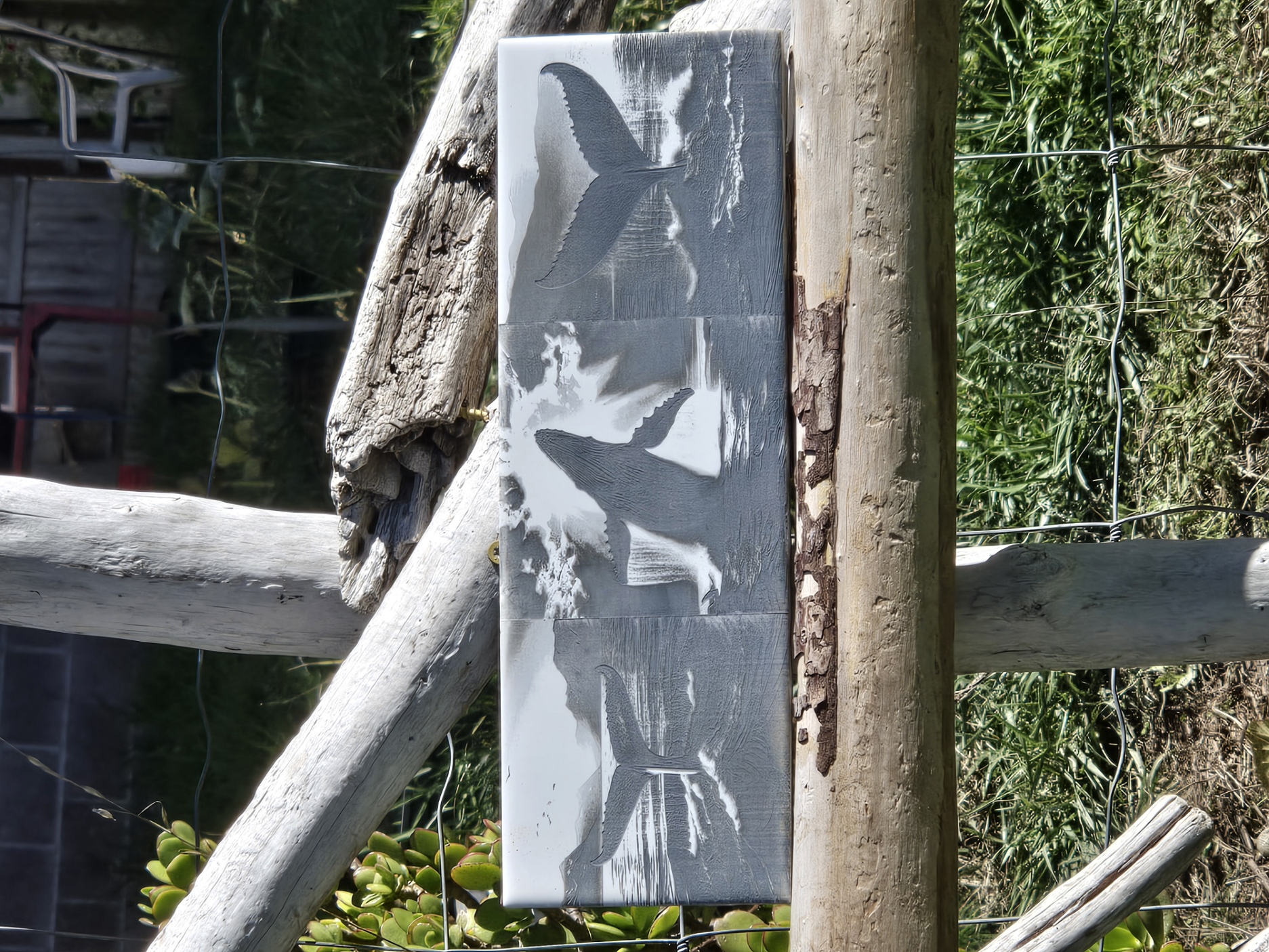 Gray whale tail relief artwork